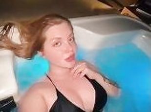 Cute sexy blonde swimming in jacuzzi outdoor