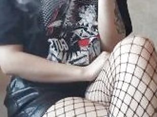 smoking girl in leather shorts and fishnet tights