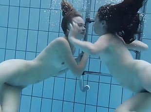 Two lovely babes enjoy making out passionately under the water