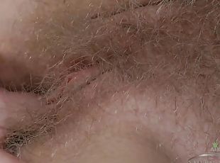 Amateur hairy cunt fingering herself close up
