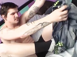 Tattooed stud tugging his hard cock and makes it squirt cum