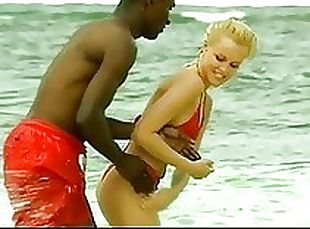 Interracial Couple Having Fun Outdoors On The Beach