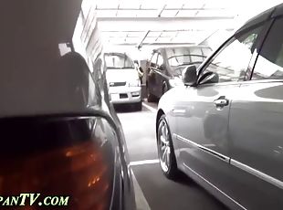 Japanase hoe takes a piss between two cars in public