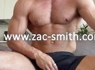 Ripped gym hunk jerks off big cock with condom