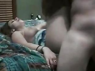 A newly married nice looking couple getting sex on bed