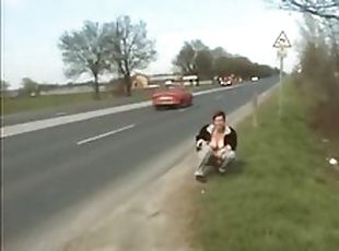 Chick pisses on the highway