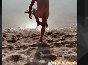 Hot boy at the beach taking his clothes off