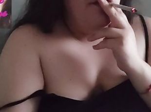 Chubby brunette smoking at home